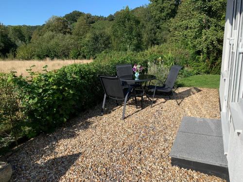 a table and chairs sitting on a gravel patio at Wingmore in Salisbury