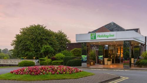 a building with a sign for a holiday inn at Holiday Inn Leeds Garforth by IHG in Garforth