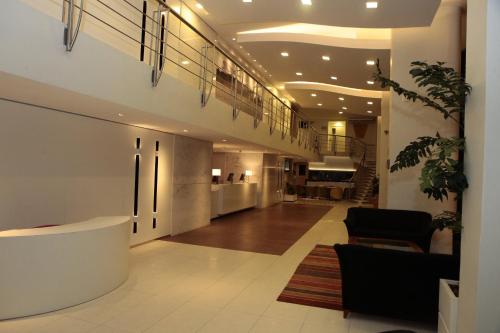 a lobby with a staircase in a building at Holiday Inn Fortaleza by IHG in Fortaleza