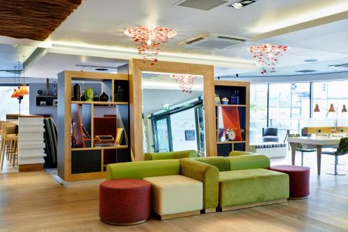 a living room with a couch and a table at Holiday Inn London Brentford Lock by IHG in Brentford