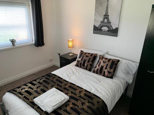 a bedroom with a bed with the eiffel tower at 5 bedrooms, 2 Reception Rooms, 2 Shower Rooms, Sleeps up to 7, Parking, Free WiFi & Netflix, Large Garden in Corby