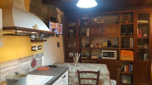 a kitchen with a table with chairs and a counter top at HOME SWEET HOME in Antey-Saint-André