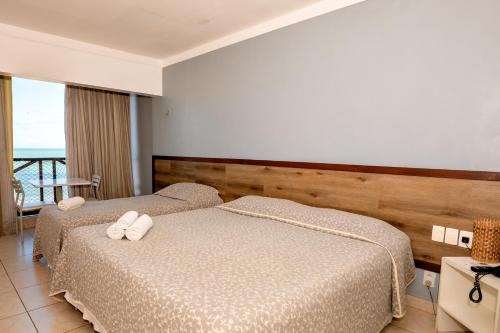 Katil atau katil-katil dalam bilik di Moriah Natal Beach Hotel