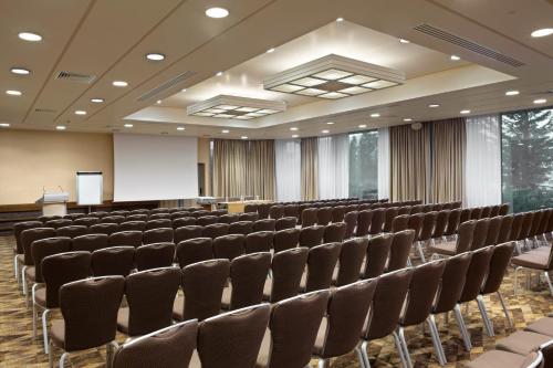 a conference room with chairs and a podium in it at Holiday Inn Athens Attica Av, Airport W. by IHG in Athens