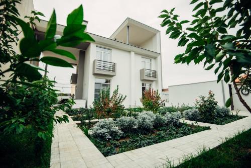 a house with a garden in front of it at Veronika Home Tbilisi in Tbilisi City