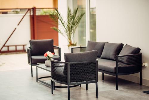 two chairs and a couch on a patio at Veronika Home Tbilisi in Tbilisi City