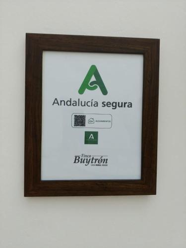 a framed picture of an adelaidevisor sign on a wall at Bodega Boutique Finca Buytrón in Montilla