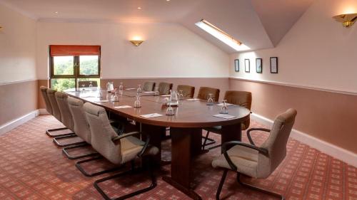 a conference room with a long table and chairs at Holiday Inn Rotherham-Sheffield M1,Jct.33 by IHG in Rotherham