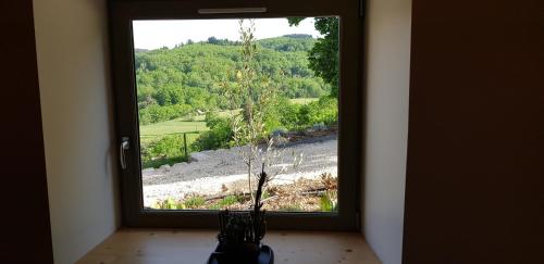 a window in a room with a view of a mountain at Gites de l'alouette in Boffres