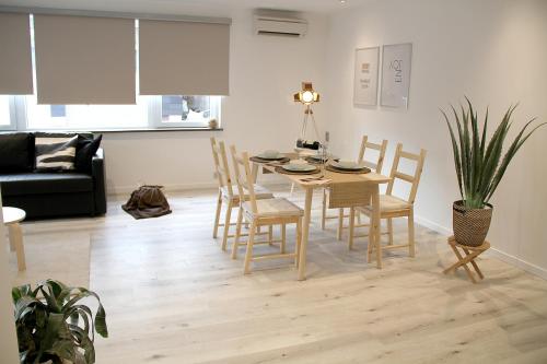 a living room with a dining room table and chairs at Appart Aldyis in Sprimont