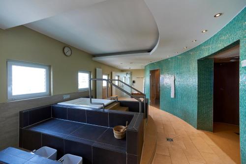 a large bathroom with a sink and a staircase at Holiday Inn Berlin Airport - Conference Centre by IHG in Schönefeld