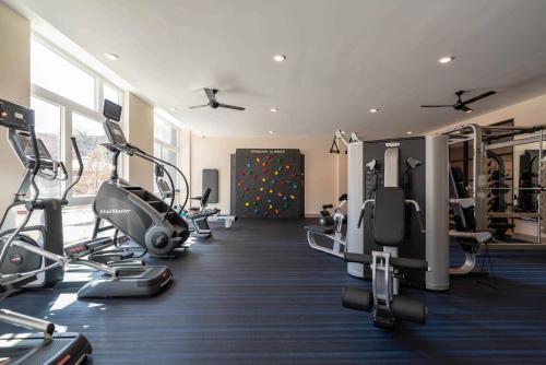 a gym with treadmills and ellipticals in a room at Luxury Furnished Apartments by Hyatus Downtown at Yale in New Haven