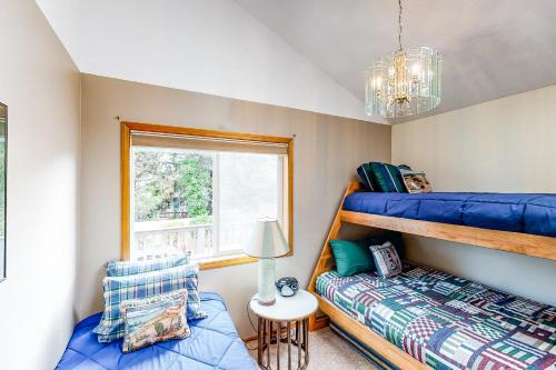 a bedroom with two bunk beds and a window at Seaside Serenade in Seaside