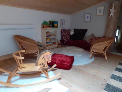 a living room with rocking chairs and a couch at la grange aux oiseaux in Arnaville