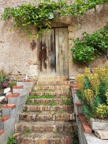 a door on a building with stairs in front of it at la grange aux oiseaux in Arnaville