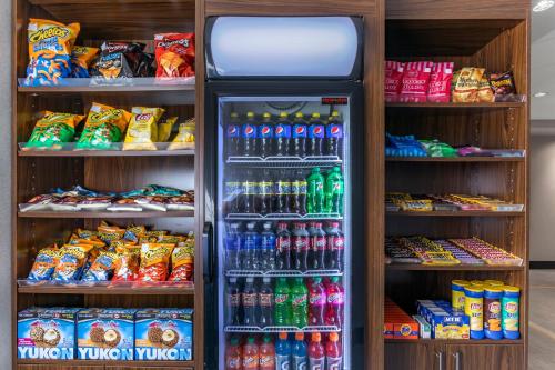 a refrigerator in a store filled with lots of soda at Comfort Inn in Sarnia