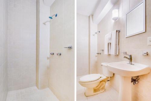a bathroom with a toilet and a sink and a shower at Hotel La Estancia in Colima
