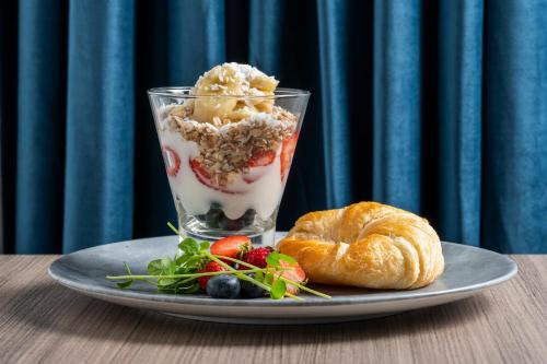 a plate of food with a dessert and a croissant at Holiday Inn Kingston - Waterfront, an IHG Hotel in Kingston