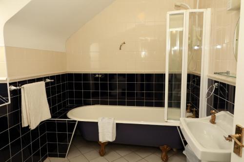 a bathroom with a tub and a sink at Arus Grattan in Galway