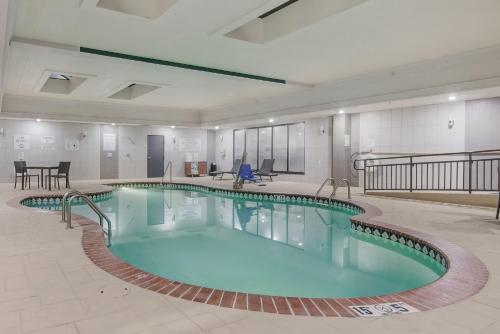 a large swimming pool in a large building at Holiday Inn Express & Suites Longview North by IHG in Longview