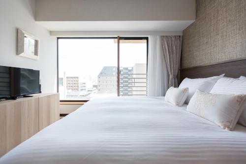 Кровать или кровати в номере R&Run Kyoto Serviced apartment & Suites - Vacation STAY 99370