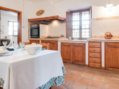 a kitchen with a table with a white table cloth on it at Relaxing Tuscan Home with WiFi in Casola in Lunigiana