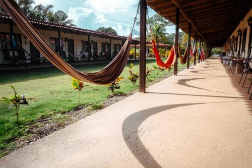 a row of hammocks hanging from a building at Beach Break Hotel & Surf Camp de Playa Venao in Playa Venao