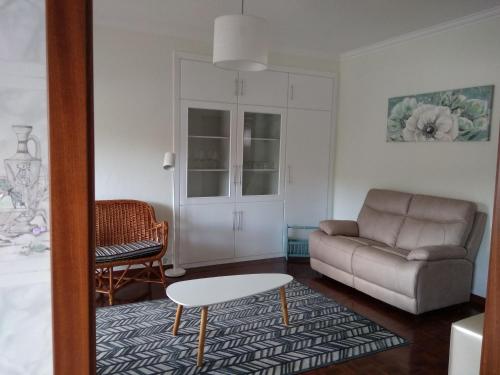 a living room with a couch and a coffee table at O Terraço da Ribeira in Sertã