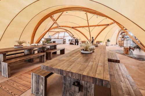 a wooden table topped with wooden benches at Under Canvas Grand Canyon in Valle