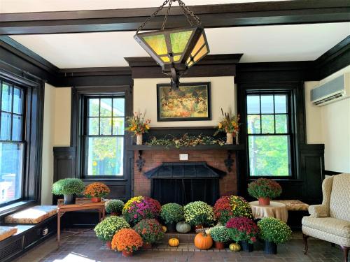 a living room with a fireplace and a bunch of pumpkins at Mercersburg Inn in Mercersburg