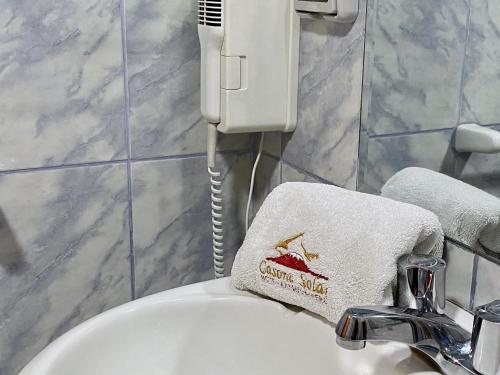 a bathroom with a white towel on a sink at Hotel Casona Solar in Arequipa