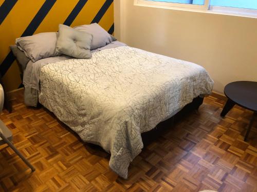 a bedroom with a bed with two pillows on it at Caravansaro Vazquez de Mella 347 Polanco in Mexico City