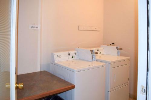 a small laundry room with a washer and dryer at Quality Inn Umatilla - Hermiston in Umatilla