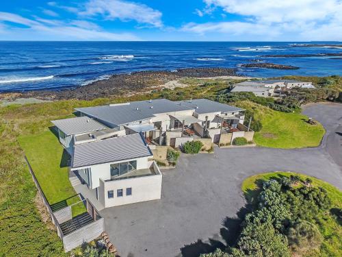 an aerial view of a house with the ocean at Hearns Beachside Villa 3 in Port Fairy