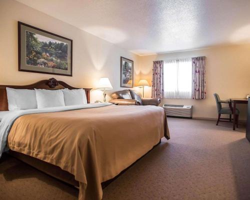 A bed or beds in a room at Quality Inn New Columbia-Lewisburg