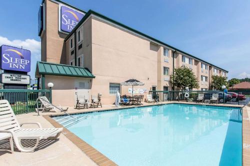 a swimming pool in front of a hotel at Sleep Inn in Nashville