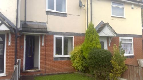 a red brick house with a black door at Cosy house for business travel and pleasure in Bickershaw