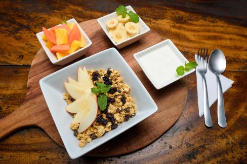 a table with a plate of food with fruit and nuts at Beach Break Hotel & Surf Camp de Playa Venao in Playa Venao