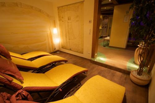 a row of chairs in a room with a mirror at Hotel Landhaus Carla in Mayrhofen