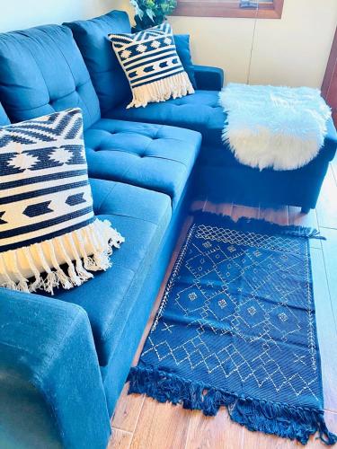 a blue couch with pillows on it in a living room at Hamilton Cove-Boho Chic Villa w/Golf Cart...No pets. in Avalon