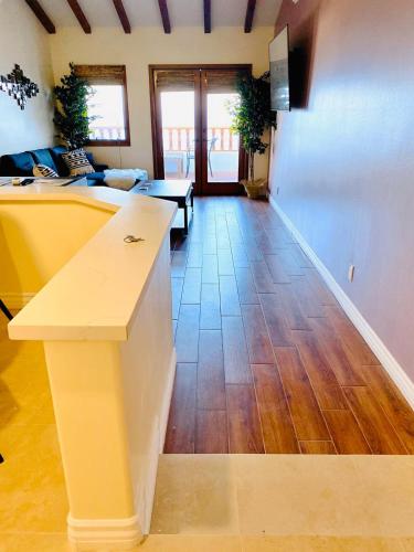 a living room with a counter and a wooden floor at Hamilton Cove-Boho Chic Villa w/Golf Cart...No pets. in Avalon