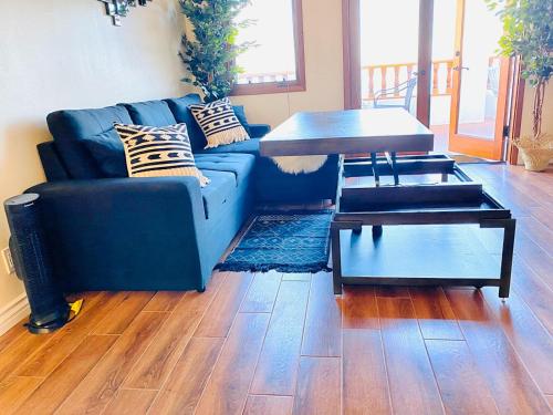 a living room with a blue couch and a table at Hamilton Cove-Boho Chic Villa w/Golf Cart...No pets. in Avalon