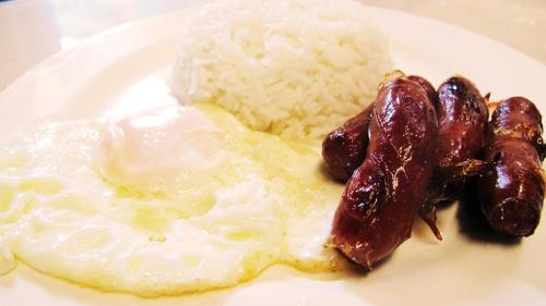 a plate of food with eggs rice and beans at CounTess Pension House in Liloan