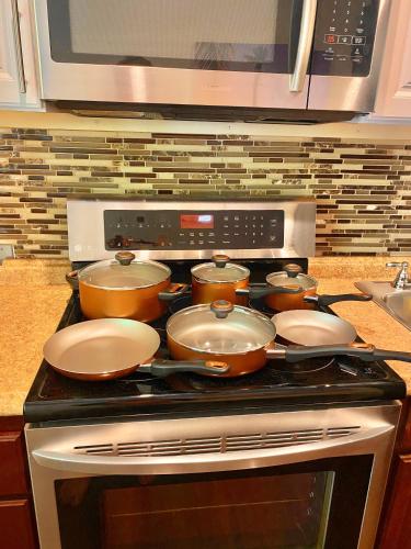 a stove with pots and pans on top of it at Beautiful Guest House Kailua Beach in Kailua