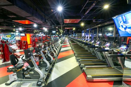 a gym with a row of treadms and machines at 雀客旅館台中來來 in Taichung