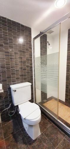 a bathroom with a toilet and a shower at Kemena Plaza Hotel in Bintulu