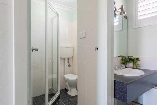 a bathroom with a toilet and a sink at Panorama Bathurst in Bathurst