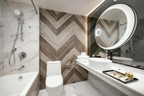 a bathroom with a sink and a mirror at Park Hotel Hong Kong in Hong Kong