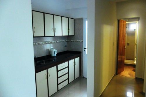 A kitchen or kitchenette at Urunday Apart Hotel