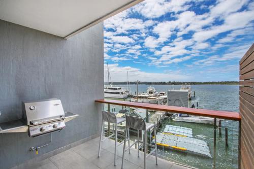 a balcony with a view of a marina at 5 Knots Metung in Metung